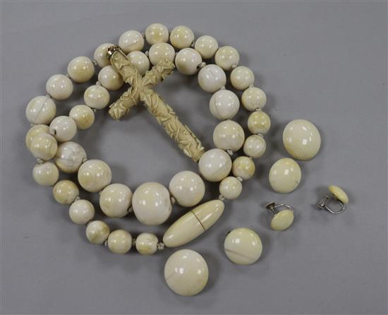 An ivory bead necklace, a carved cross and three pairs of earrings.
